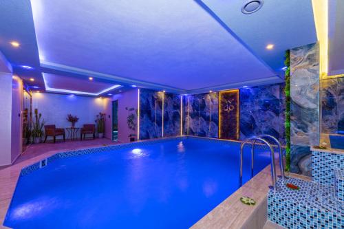 a large swimming pool in a large room with at Bekdas Hotel Deluxe & Spa in Istanbul