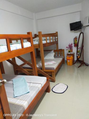 
A bunk bed or bunk beds in a room at Family room, Pagudpud ilocos norte
