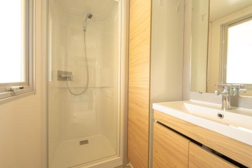 a bathroom with a shower and a sink at Marino Mobilhomes in Grimaud