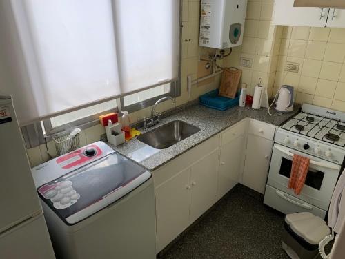 a small kitchen with a sink and a stove at San Isidro Flat in San Isidro