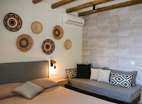 a bedroom with a bed and a couch at Haraki Blue Pearl Luxury studio in Haraki