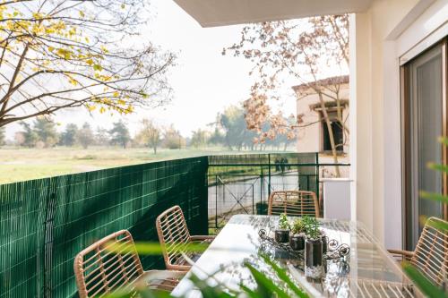 a table and chairs on the balcony of a house at Grand Lux Apartment in Serres