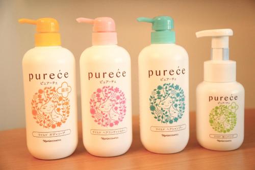 four bottles of pure squeeze on a wooden table at Yoshitsuki kaku - Yoshitsuki Apart Hotel in Tokyo