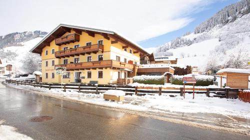 a building in the snow next to a road at Rainberghof***, Appartements in Rauris
