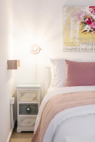 a bedroom with a bed and a night stand at Grand Lux Apartment in Serres