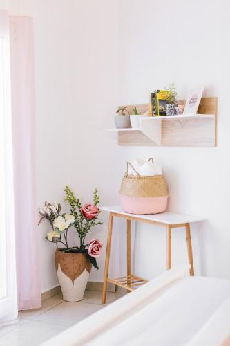 a white room with a table with plants and shelves at Grand Lux Apartment in Serres