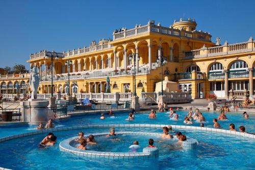 a group of people in a pool in front of a building at Park&Art Boutique Suites in Budapest