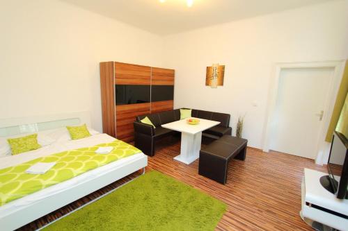 a bedroom with a bed and a table and chairs at Apartment Simmering in Vienna