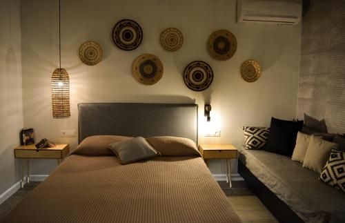 a bedroom with a bed and a couch at Haraki Blue Pearl Luxury studio in Haraki