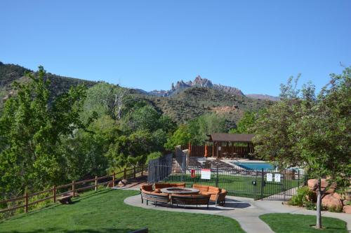 a resort with a swimming pool and mountains in the background at Hyatt Place Springdale - Zion National Park in Springdale
