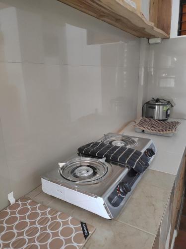a stove top oven sitting on a counter in a kitchen at Goodie's Place in Baguio