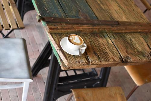 a cup of coffee sitting on a wooden table at Penzion U Kapličky in Znojmo