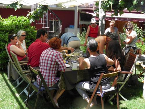 a group of people sitting around a table at Hostal Rural Txapi Txuri Logis Hotels in Murillo el Fruto