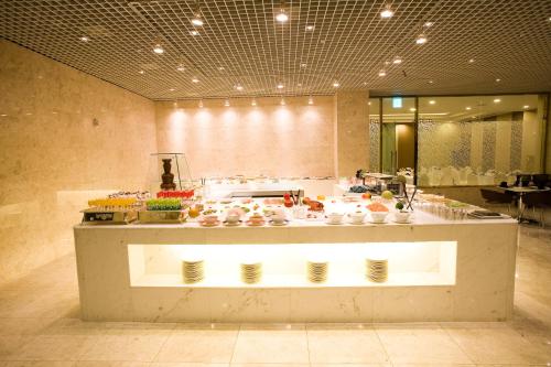 a buffet line with food on display in a restaurant at Daegu Grand Hotel in Daegu