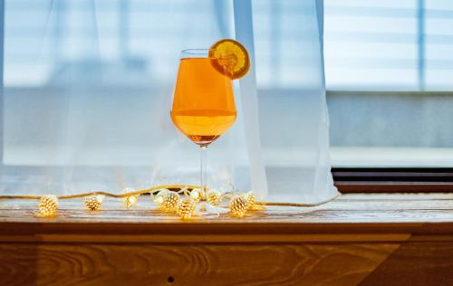 a glass of orange juice sitting on a window sill at A&M Hotel with free parking in Plovdiv