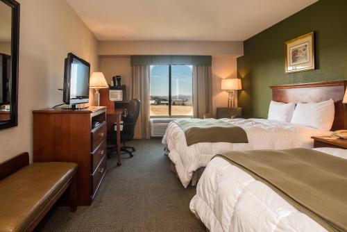 a hotel room with two beds and a television at Round Hill Inn in Orange