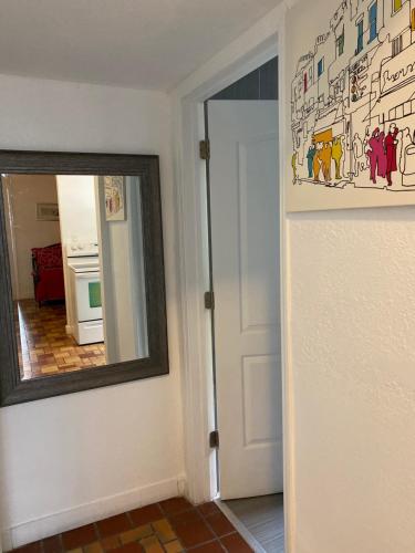 a mirror on a wall next to a hallway at Harding Boutique Apartments in Miami Beach