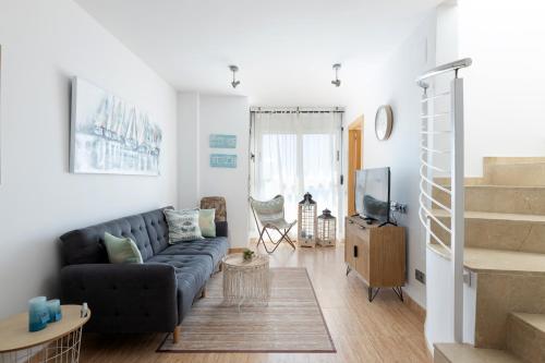 a living room with a couch and a tv at matarolux17 in Mataró