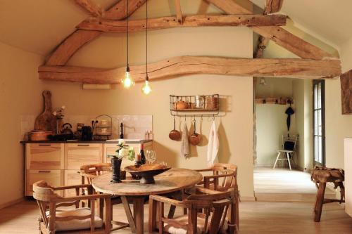 una cucina con tavolo e sedie in una stanza di B&B Sapere a Genoelselderen