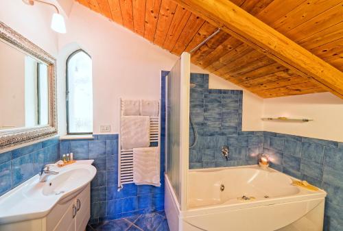 a bathroom with a tub and a sink at Villa Lieta in Ischia