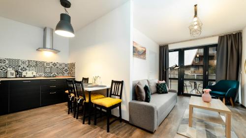 a living room with a couch and a table at Triventi Mountain Residence, Sun & Snow in Karpacz