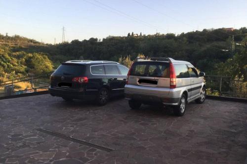 two cars are parked in a parking lot at Casetta Helena in Trieste