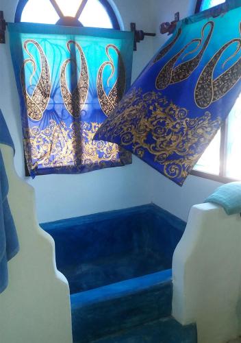 a room with a bed and pillows and a window at Laguna Palace Zanzibar in Michamvi