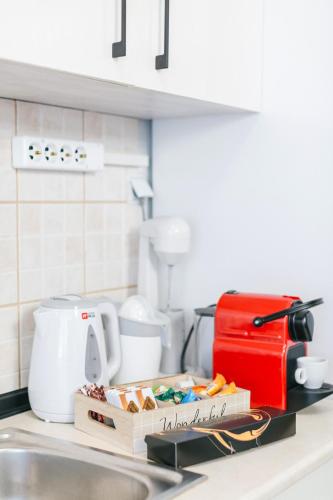 a kitchen counter with a box of food and a mixer at Grand Lux Apartment in Serres