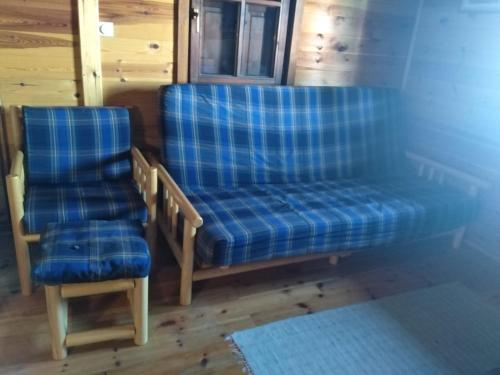 a couple of chairs sitting in a room at Apartmani Milojević in Divčibare