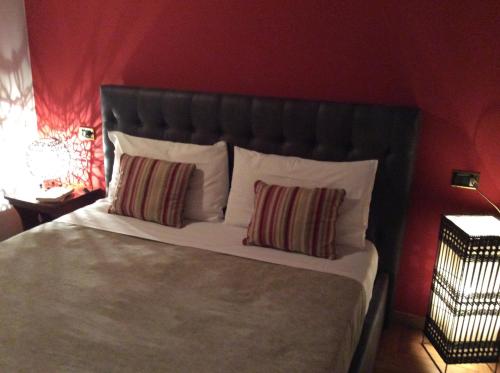 a bedroom with a large bed with two pillows at La Corte Dei Cappuccini in Bergamo
