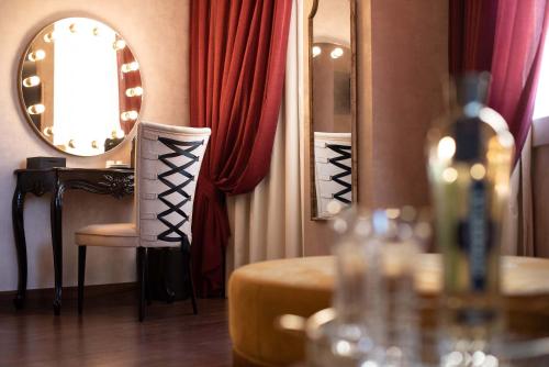 a table with a bottle of wine and a mirror at Maxime Boutique Hotel Avenida da Liberdade in Lisbon