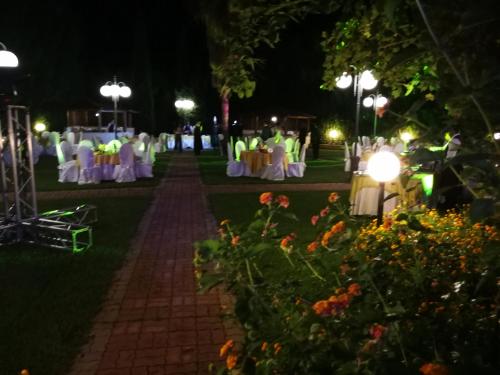 a garden wedding at night with tables and chairs at Hotel Villa Santa Maria in Villapiana