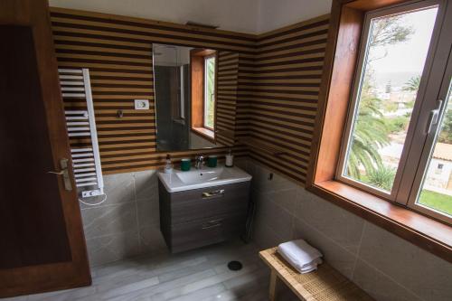 a bathroom with a sink and a mirror and a window at Villa María in La Laguna