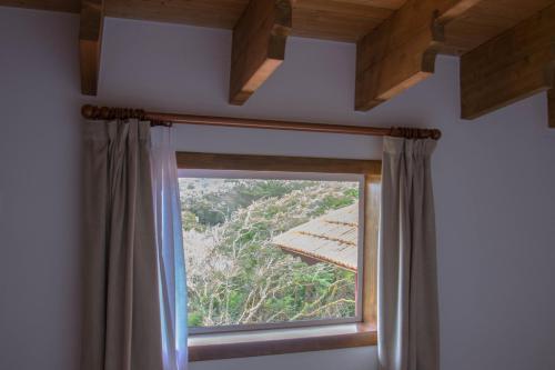 a window with a curtain in a room at Villa María in La Laguna