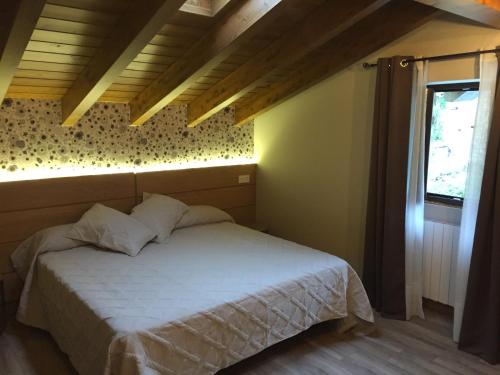 a bedroom with a white bed in a room at ETXEARTZI in Arciniega