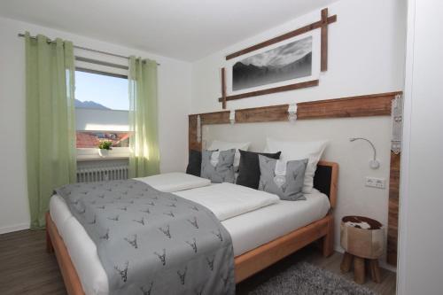 a bedroom with a large bed and a window at Dorfliebe in Oy-Mittelberg