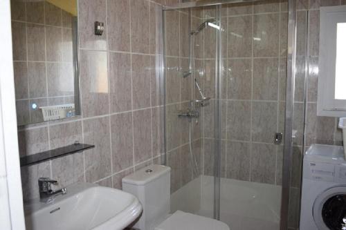 a bathroom with a shower and a toilet and a sink at casa con amarre privado ref 214 in Empuriabrava