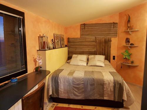 a bedroom with a bed and a desk and a window at Castell de Fonolleres in Fonolleres