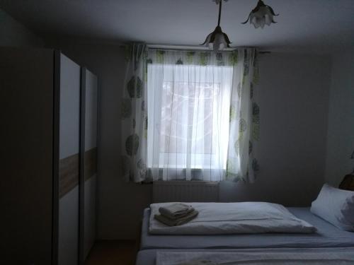 a bedroom with two beds and a window at Apartment Waldhaus Opitz in Zell am See