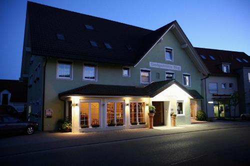 a house with lights on the front of it at Landgasthof Bieg in Neuler