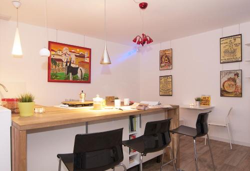 a kitchen with a desk and chairs in a room at Modica Old Town Rooms in Modica