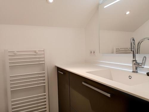 a bathroom with a sink and a mirror at La Viralamande by Cocoonr in Crépieux-la-Pape