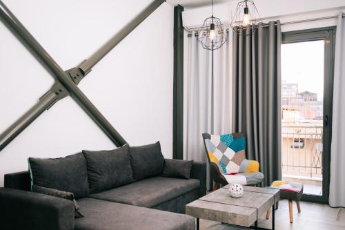 a living room with a couch and a table at Volos Suites Center in Volos