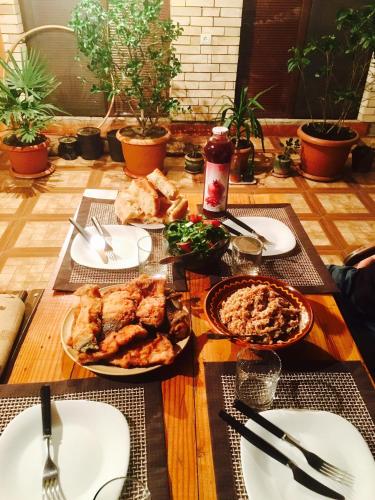 a wooden table with plates of food on it at Family Mini-Hotel Martirosyan's and tours in Yerevan