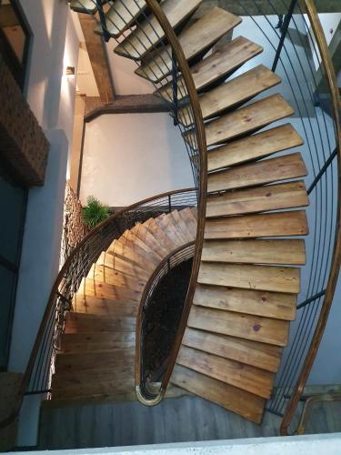 a spiral staircase in a building with a metal railing at Taba Hall Boutique Hotel in Akhaltsikhe