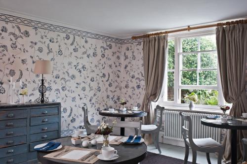 a dining room with a table and chairs and a window at The Old Rectory in Hastings