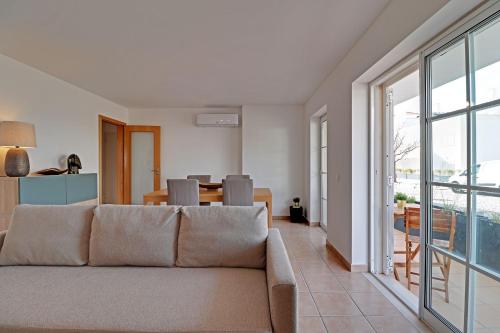 a living room with a couch and a table at Tavira Formosa Bay 1 by Homing in Cabanas de Tavira
