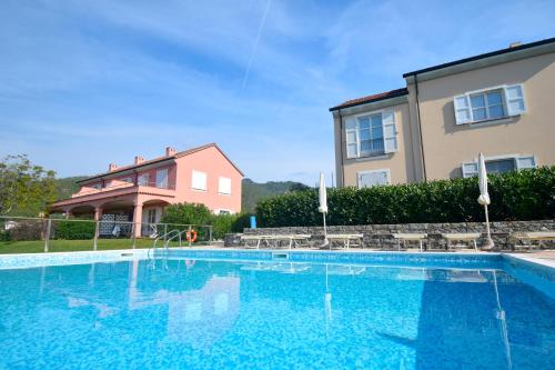 a large swimming pool in front of a house at Case Vacanze Malonghe in Deiva Marina
