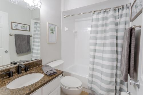 a bathroom with a sink and a toilet and a shower at La Casa Del Mar 608 Star5Vacations in Dunedin