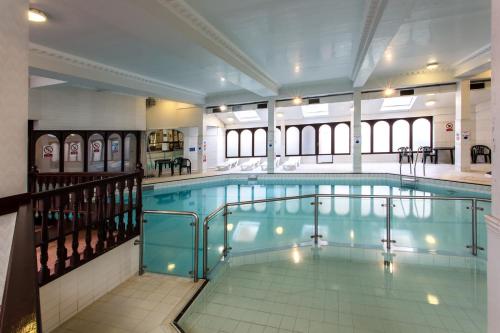 a large swimming pool with a pool at Britannia Country House Hotel & Spa in Manchester